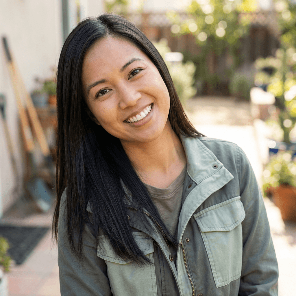Friendly female cafe owner standing in her bright coffee shop